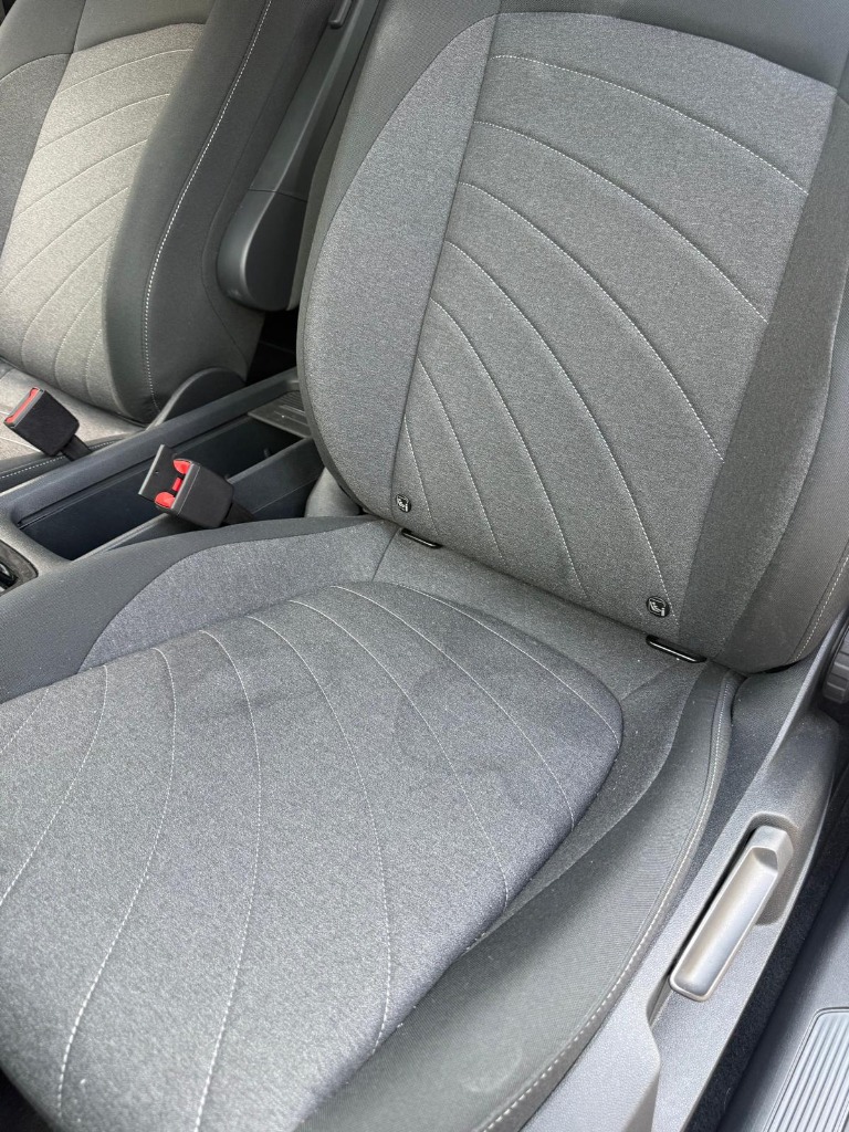 Pet urine stain on fabric seat cushion before professional deep extraction